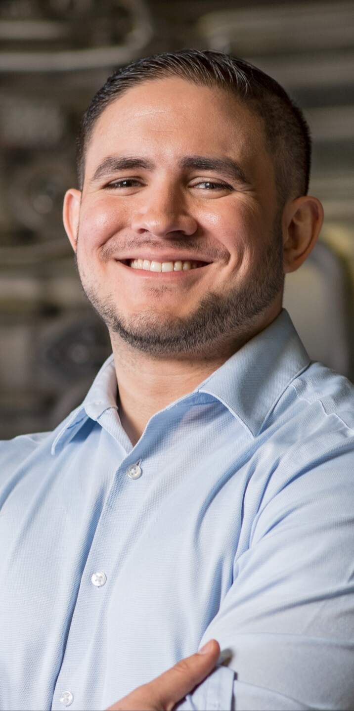 a man wearing glasses and smiling at the camera