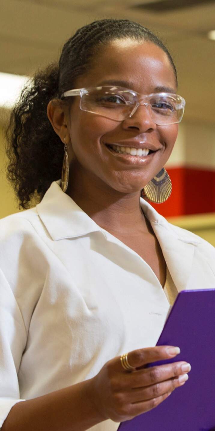 a person wearing glasses and smiling at the camera